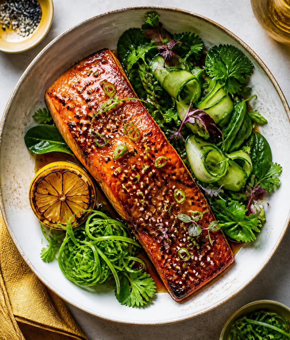 A vibrant miso salmon dish adapted by Eatvia with fresh greens and golden accents